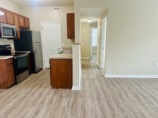 A kitchen with a refrigerator, microwave, and oven at The Greyson, OH, 43026