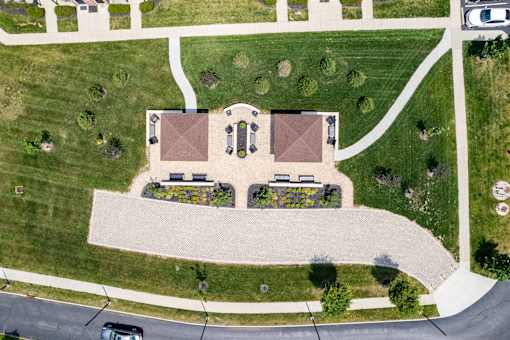 A park with a building and a paved walkway.at The Greyson, Hilliard, Ohio