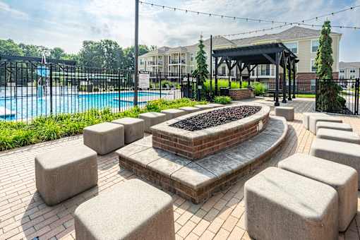 A pool area with a fire pit and seating area.at The Greyson, Hilliard