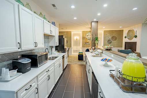 A kitchen with white cabinets and a black refrigerator. at The Greyson, Ohio, 43026