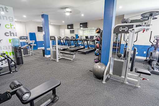 A gym with a variety of equipment including weights and machines. at The Greyson, Ohio