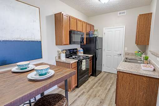A kitchen with a refrigerator, microwave, oven, and sink.at The Greyson, Hilliard, 43026