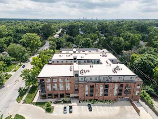 A large building with a parking lot in front of it. at The MK, Indianapolis, IN