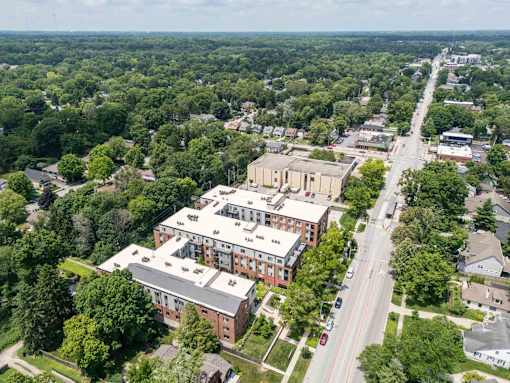 An aerial view of a street with a red brick building on the corner. at The MK, Indiana, 46220