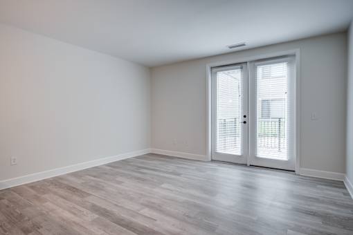 A room with a sliding door and wooden flooring. at The MK, Indianapolis
