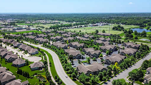 A suburban neighborhood with houses and a winding road at Sovereign at Overland Park Apartments, Overland Park, KS