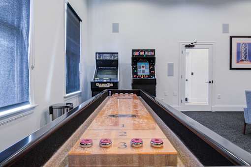 A bowling alley with a wooden lane and a pinsetter at Sovereign at Overland Park Apartments, Overland Park