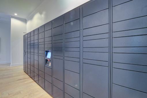 A wall of lockers with a keypad on the front at Sovereign at Overland Park Apartments, Overland Park, 66213