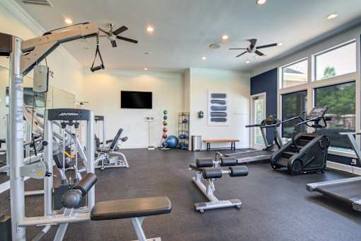 A spacious home gym with a variety of exercise equipment at Sovereign at Overland Park Apartments, Overland Park, 66213