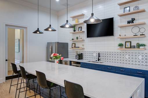 A kitchen with a white countertop and blue cabinets at Sovereign at Overland Park Apartments, Overland Park Kansas