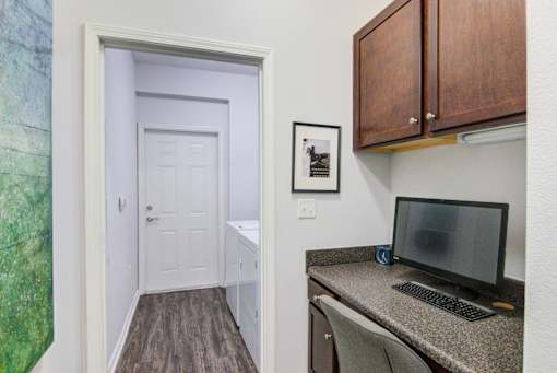 A room with a desk and a computer monitor at Sovereign at Overland Park Apartments, Overland Park, KS