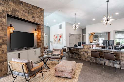 A modern living room with a stone wall and a flat screen TV.