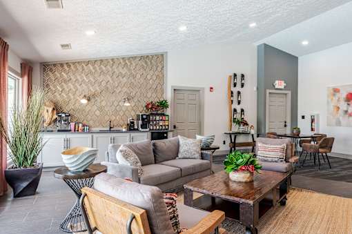 A living room with a grey couch and a wooden coffee table.