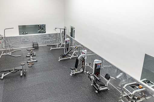 A gym with a variety of exercise equipment.