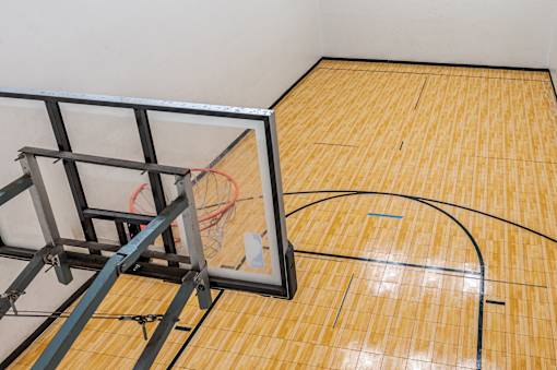 A basketball court with a hoop and a net.