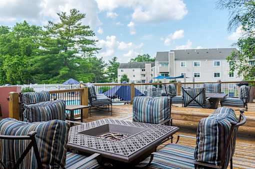 A patio with striped chairs and a table.