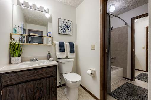 A bathroom with a white toilet and a white sink.