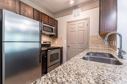 Kitchen with Granite Countertops at Waterstone at Cinco Ranch Apartments, Texas