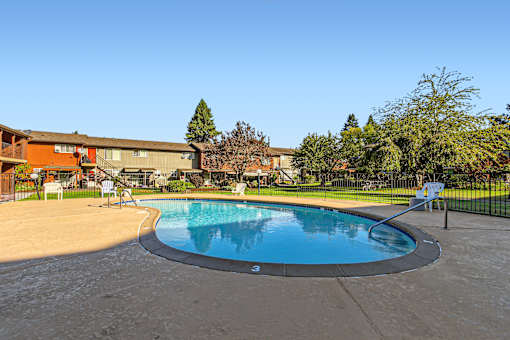 A small round pool with a concrete floor and a concrete wall around it.
