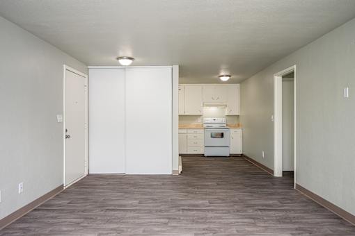 A kitchen with white cabinets and appliances is shown.