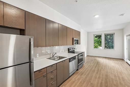 A modern kitchen with wooden cabinets and stainless steel appliances.