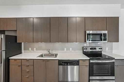 A modern kitchen with a stainless steel dishwasher and oven.