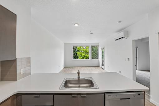 A modern kitchen with a large sink and a window.