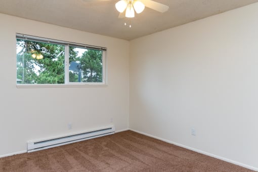 Pinewood Terrace Apartments | First bedroom with carpet and window