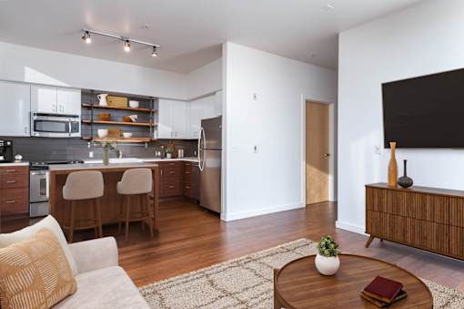 A modern kitchen with a dining table and chairs.