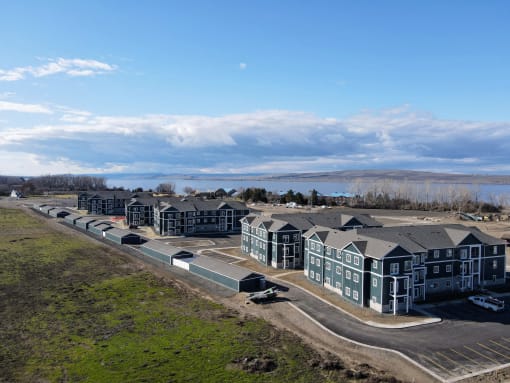 an aerial view of a row of houses in front of a lake