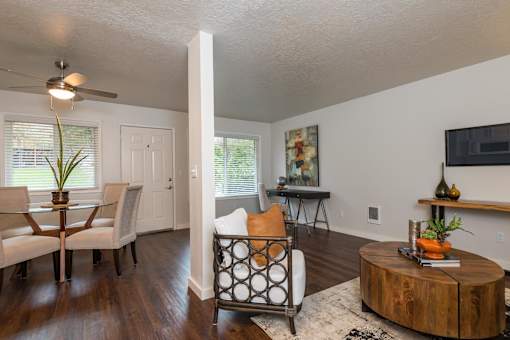 A living room with a white ceiling and a wooden coffee table.