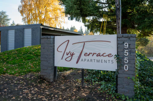 a sign for the ivy terrace apartments in front of a building