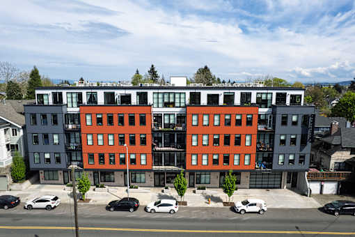 A modern multi-story building with a black and orange facade.