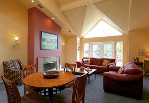 A living room with a fireplace and a painting on the wall.