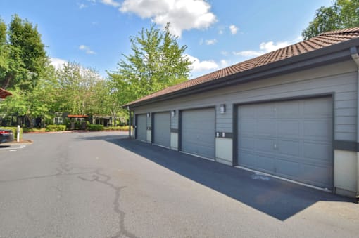 A residential building with a grey garage door.