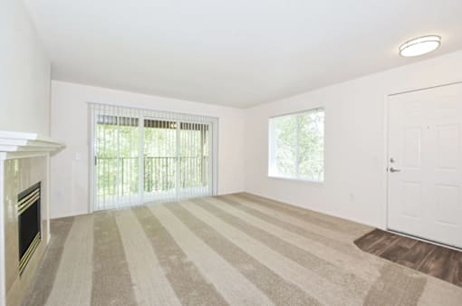 A room with a fireplace and striped carpet.