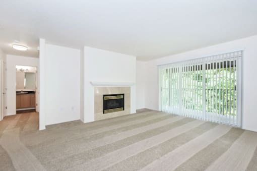 A living room with a fireplace and striped carpet.