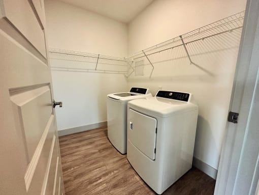 a laundry room with two washes and a dryer in it
