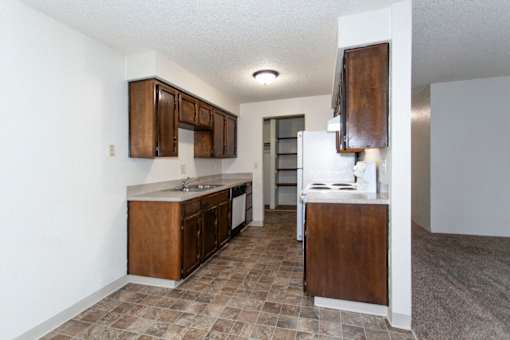 a kitchen with wooden cabinets and a white refrigerator
