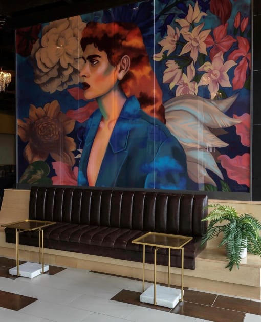 a painting of a woman in a blue suit and a lobby with benches