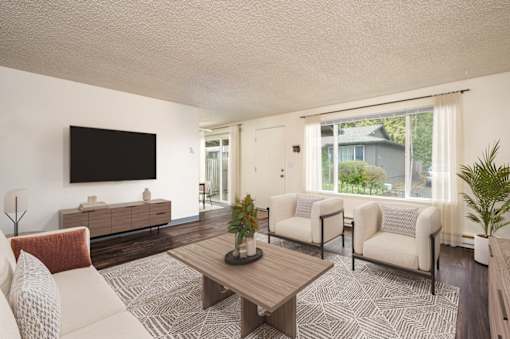 A living room with a flat screen TV mounted on the wall.