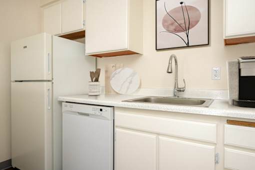 A white fridge and dishwasher in a kitchen.