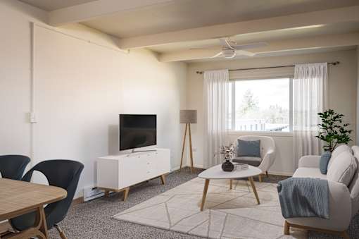 A living room with a television, chairs, and a table.