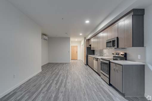 A kitchen with a stove top oven and microwave.