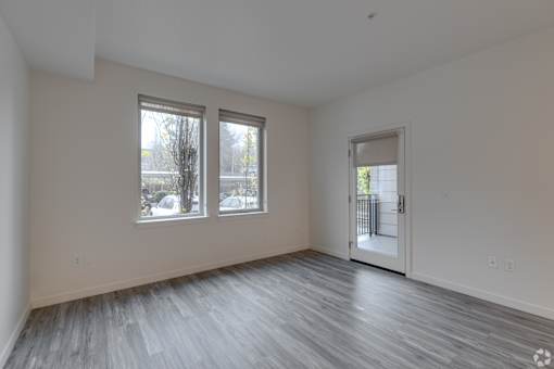 A room with a door and two windows.