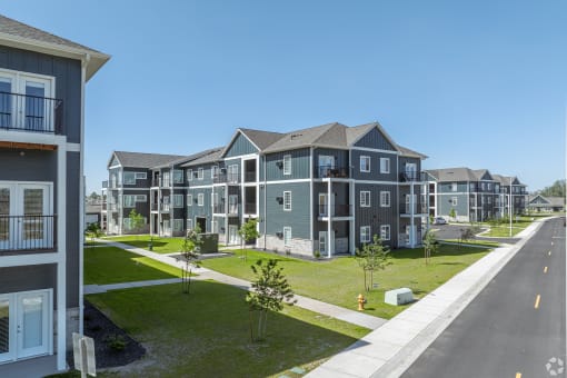 an image of an apartment building on the side of a street
