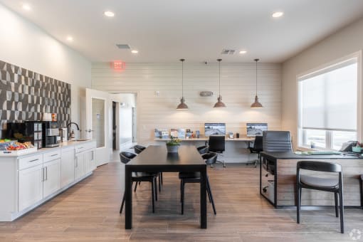 an open kitchen and dining area with a table and chairs and a kitchen counter top