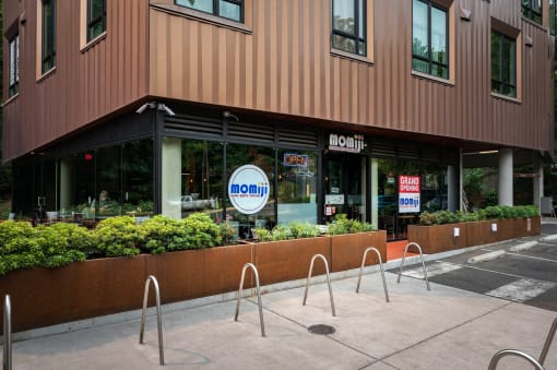 a sidewalk in front of a building with a noon sign
