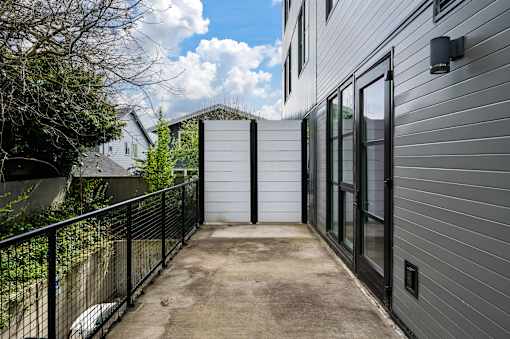 A concrete pathway leads to a white garage door.