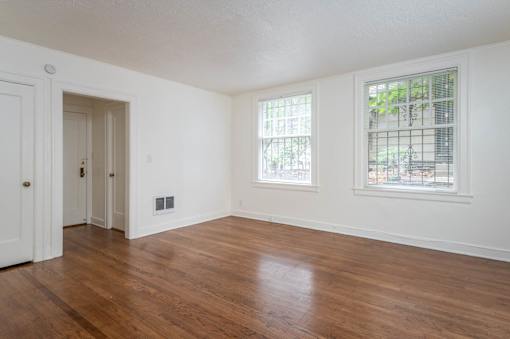 A room with a wooden floor and a window.